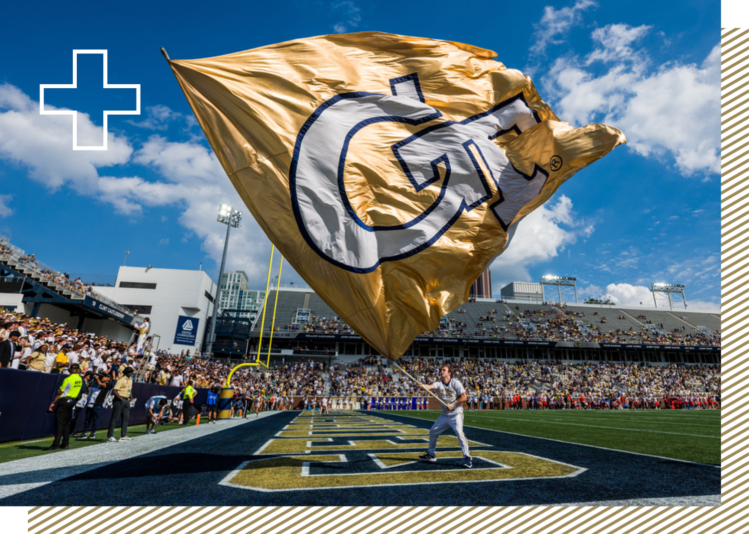 Student waving GT flag at game